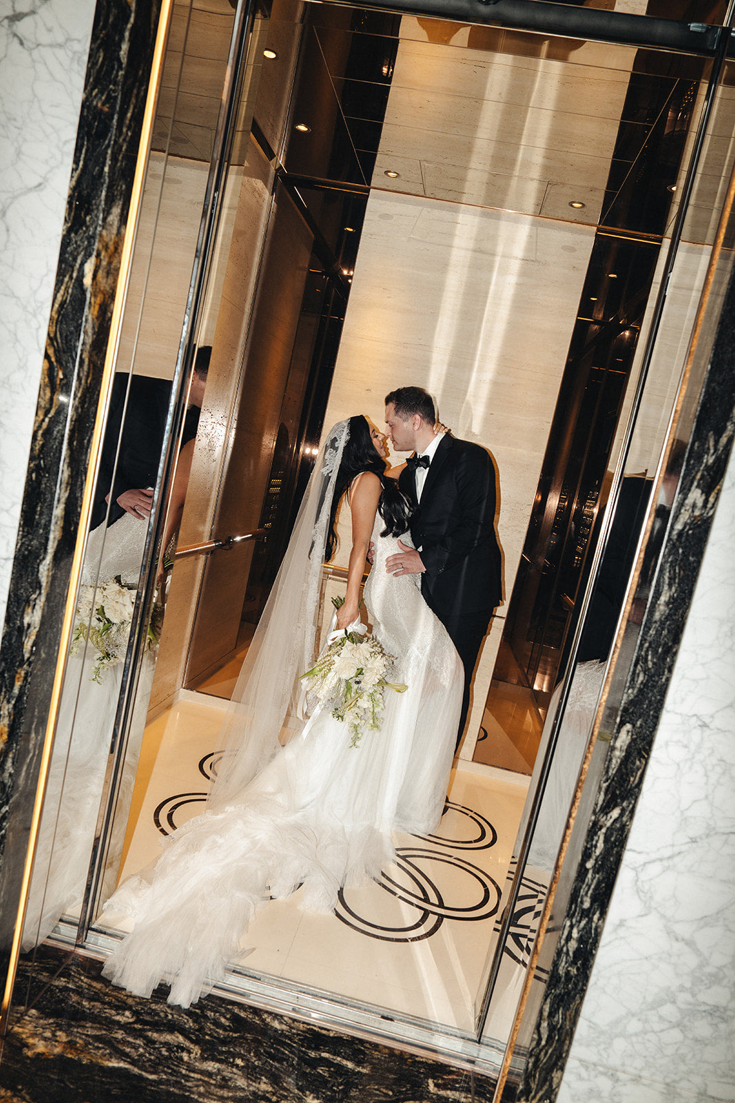 Bride and groom inside Crown Perth lift on wedding day