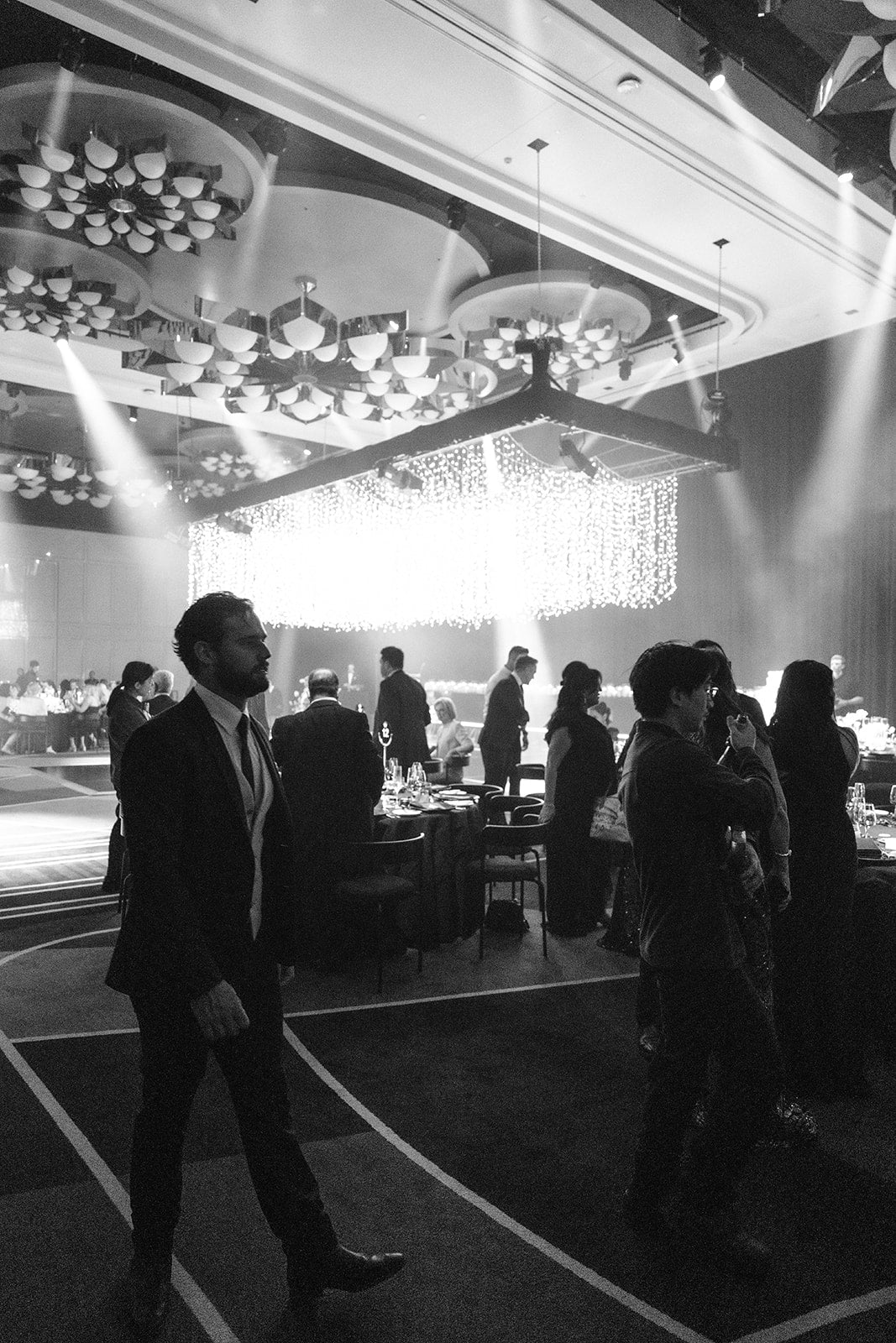 Guests mingling inside Crown Perth ballroom during wedding reception