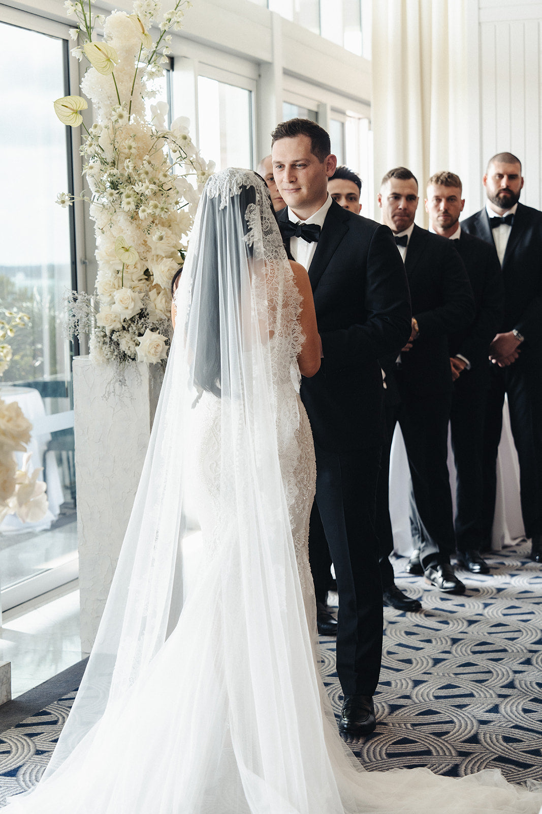 Bride and groom facing each other during Crystal Club ceremony at Crown Perth